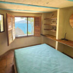 Main bedroom with new large window giving a view over the property and Laguna